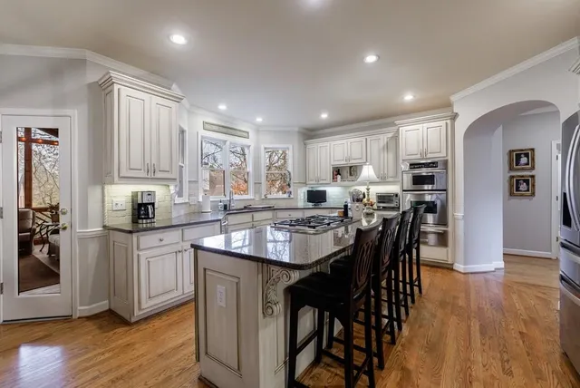 a kitchen with white cabinets and appliances