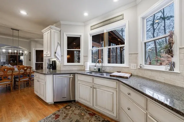 a view of a dining room with furniture wooden floor and chandelier