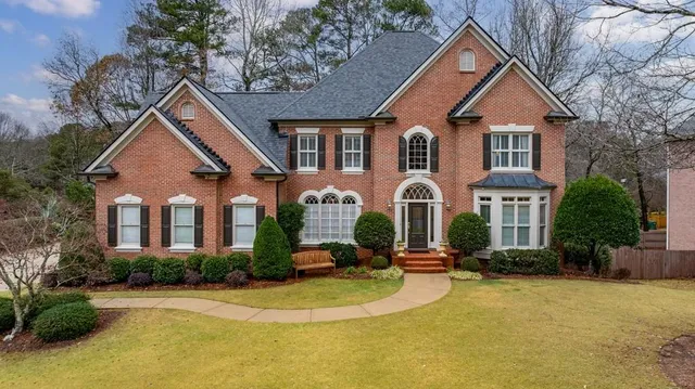 a front view of a house with a yard