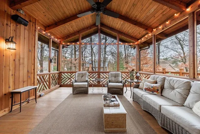 a bathroom with a granite countertop sink a large mirror and a shower