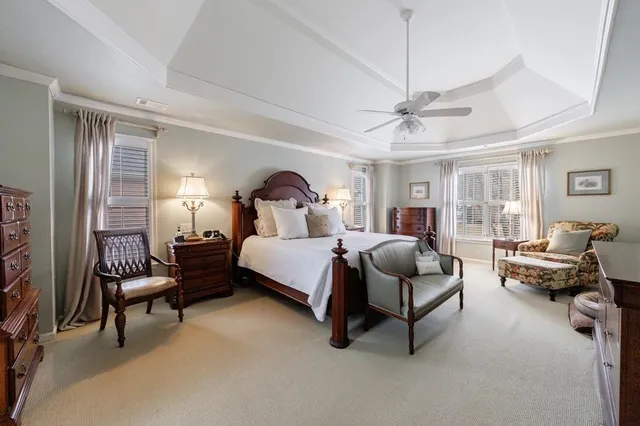 a living room with furniture a large window and a flat screen tv
