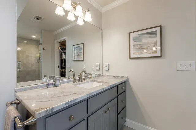 a view of a house with a yard and pathway