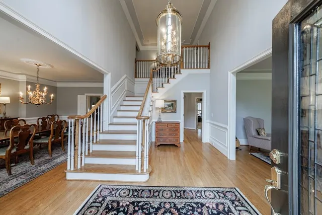 a living room with furniture a rug a lamp and a rug