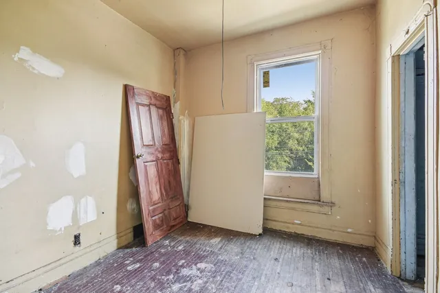 a view of livingroom with entryway and wooden floor