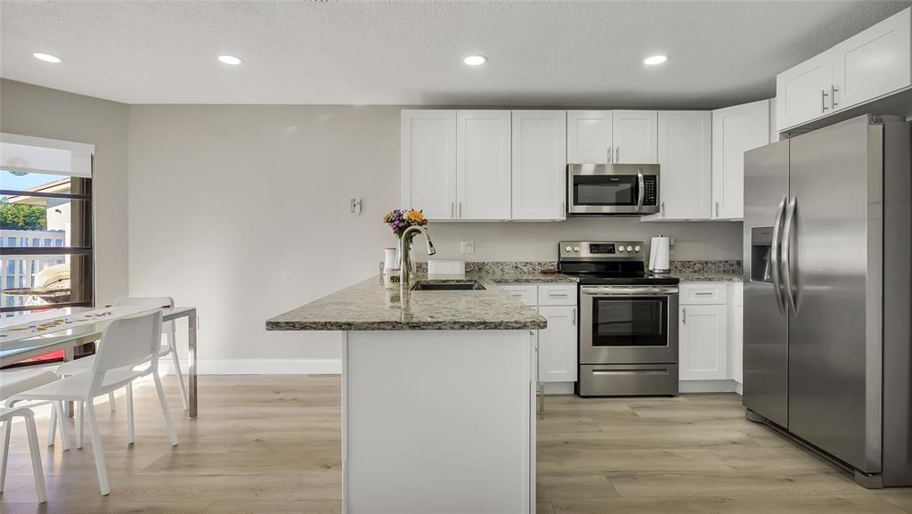 16932 Southwest 5th Way Weston, FL 33326 - Photo 3 of 49 Beautifully remodeled. Laminate wood flooring throughout, granite counters, Stainless Steel Frigidaire Appliances & Pantry.