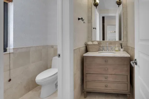 a bathroom with a sink vanity and a mirror