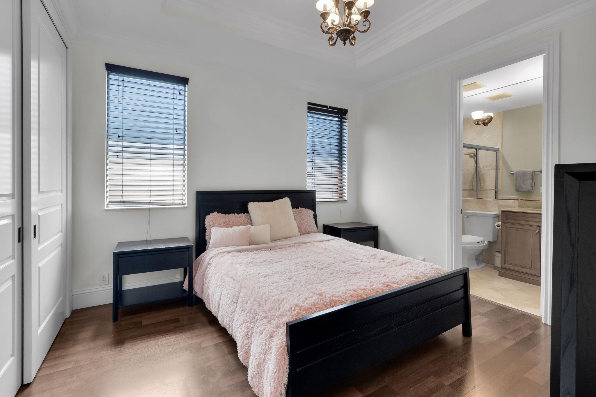 22175 Larkspur Trail Boca Raton, FL 33433 - Photo 29 of 40 a bedroom with a bed and a chandelier