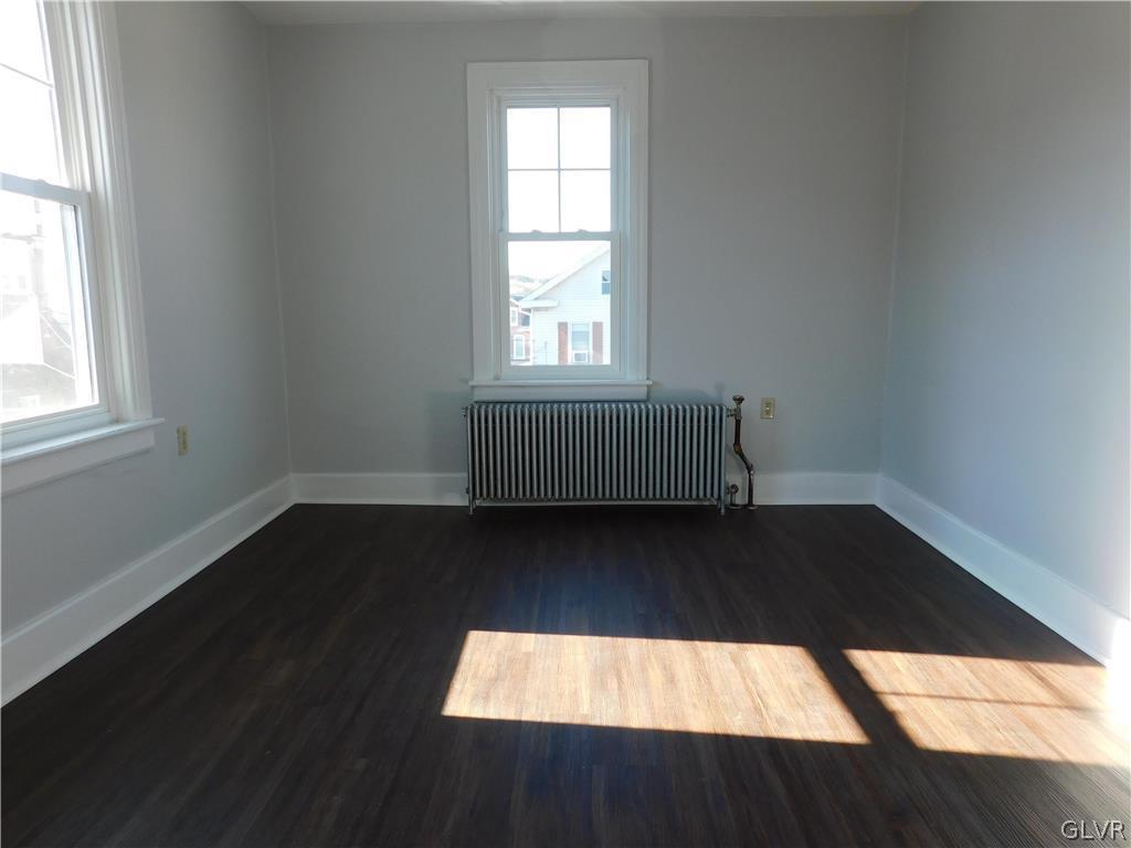 213 Penn Street Bath, PA 18014 - Photo 13 of 35 an empty room with wooden floor and windows