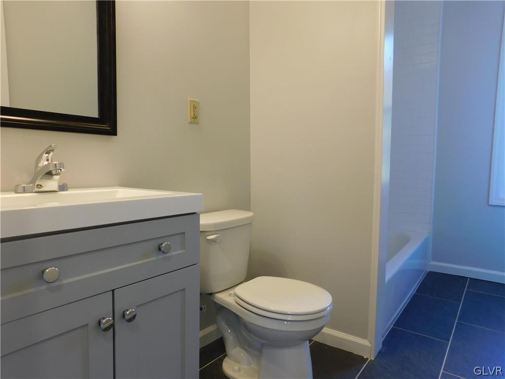 213 Penn Street Bath, PA 18014 - Photo 14 of 35 a bathroom with a sink a toilet and mirror