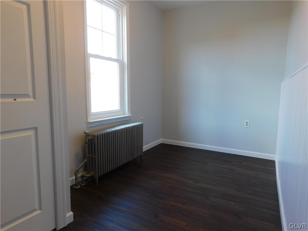 213 Penn Street Bath, PA 18014 - Photo 16 of 35 an empty room with wooden floor and windows