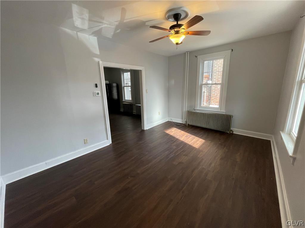213 Penn Street Bath, PA 18014 - Photo 18 of 35 a view of an empty room with a window and wooden floor