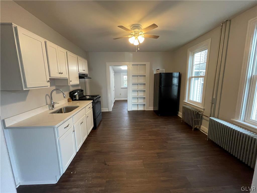213 Penn Street Bath, PA 18014 - Photo 20 of 35 a large kitchen with a large window a refrigerator and a sink
