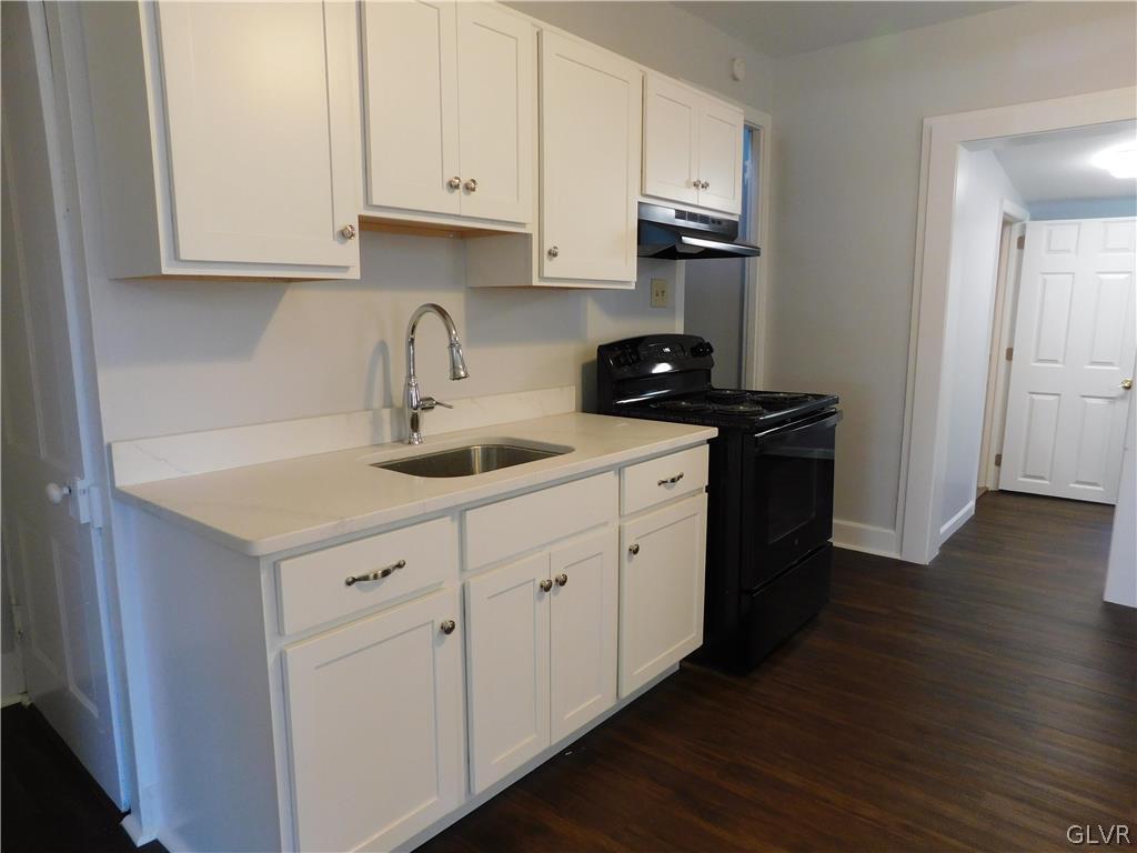 213 Penn Street Bath, PA 18014 - Photo 22 of 35 a kitchen with granite countertop white cabinets and stainless steel appliances