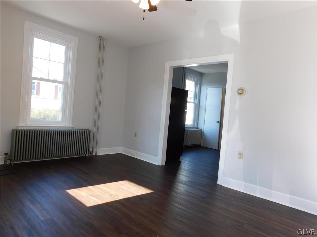 213 Penn Street Bath, PA 18014 - Photo 3 of 35 an empty room with wooden floor and windows