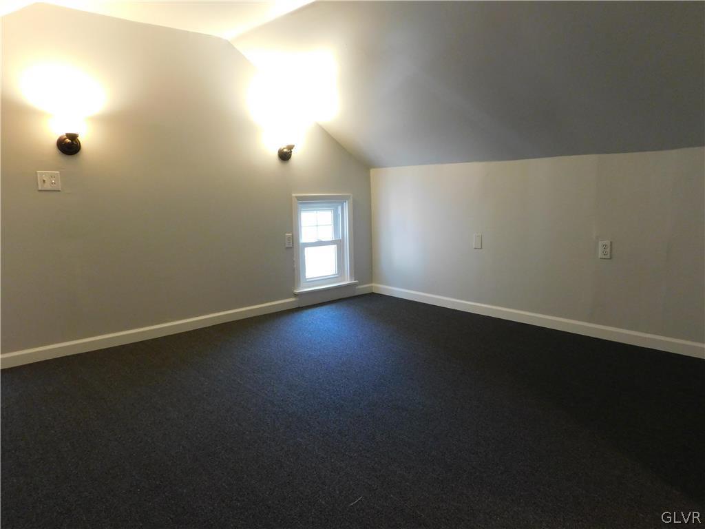 213 Penn Street Bath, PA 18014 - Photo 32 of 35 an empty room with wooden floor and windows with curtains