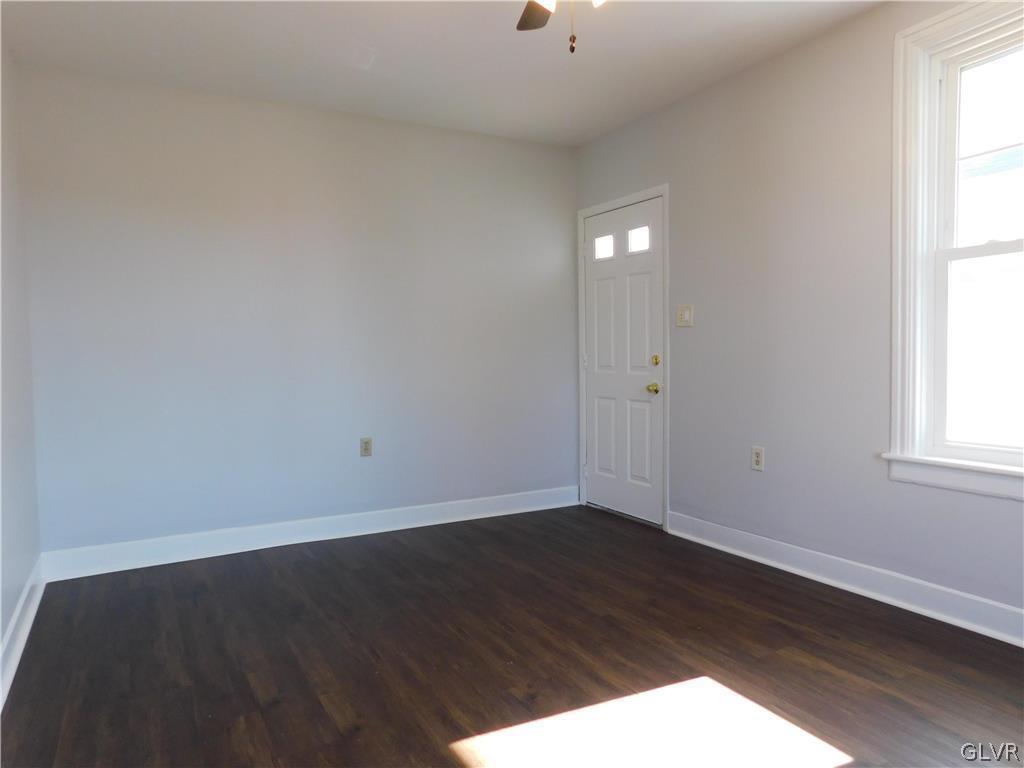 213 Penn Street Bath, PA 18014 - Photo 4 of 35 an empty room with wooden floor and windows
