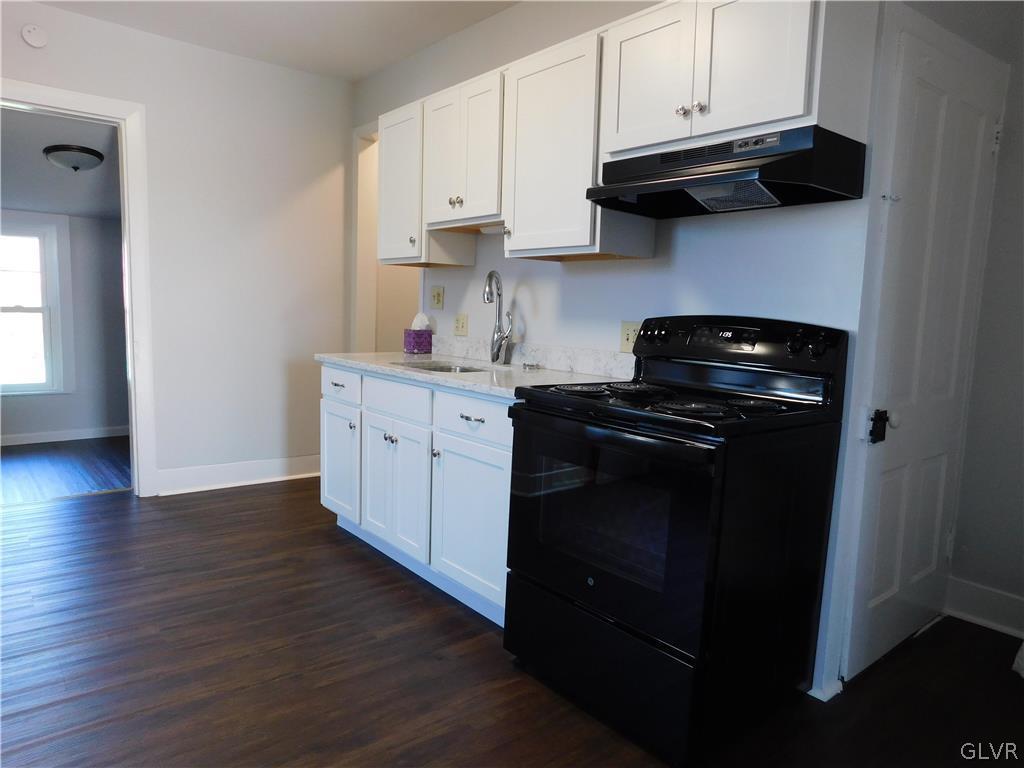 213 Penn Street Bath, PA 18014 - Photo 5 of 35 a kitchen with stainless steel appliances granite countertop a stove a refrigerator and cabinets