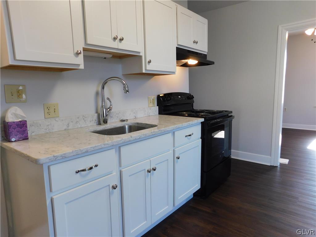 213 Penn Street Bath, PA 18014 - Photo 6 of 35 a kitchen with stainless steel appliances granite countertop a sink a stove and a wooden floors