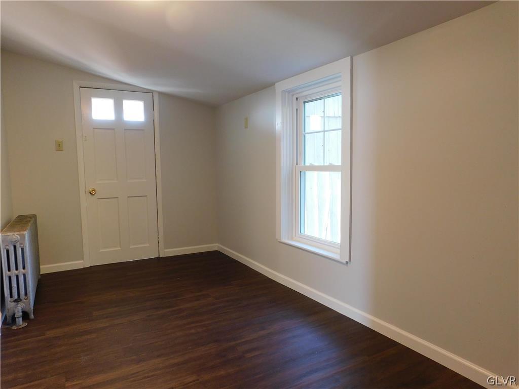 213 Penn Street Bath, PA 18014 - Photo 10 of 35 an empty room with wooden floor and windows