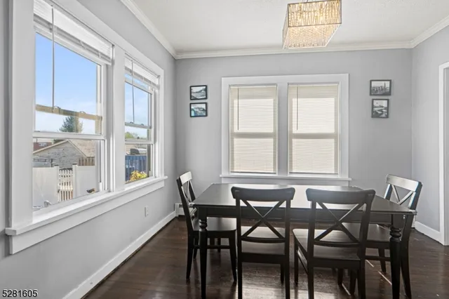 a living room with white cabinets furniture and a dining table