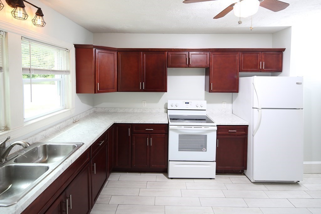 137 Mendon Road Attleboro, MA 02703 - Photo 11 of 24 a kitchen with stainless steel appliances a refrigerator sink and cabinets