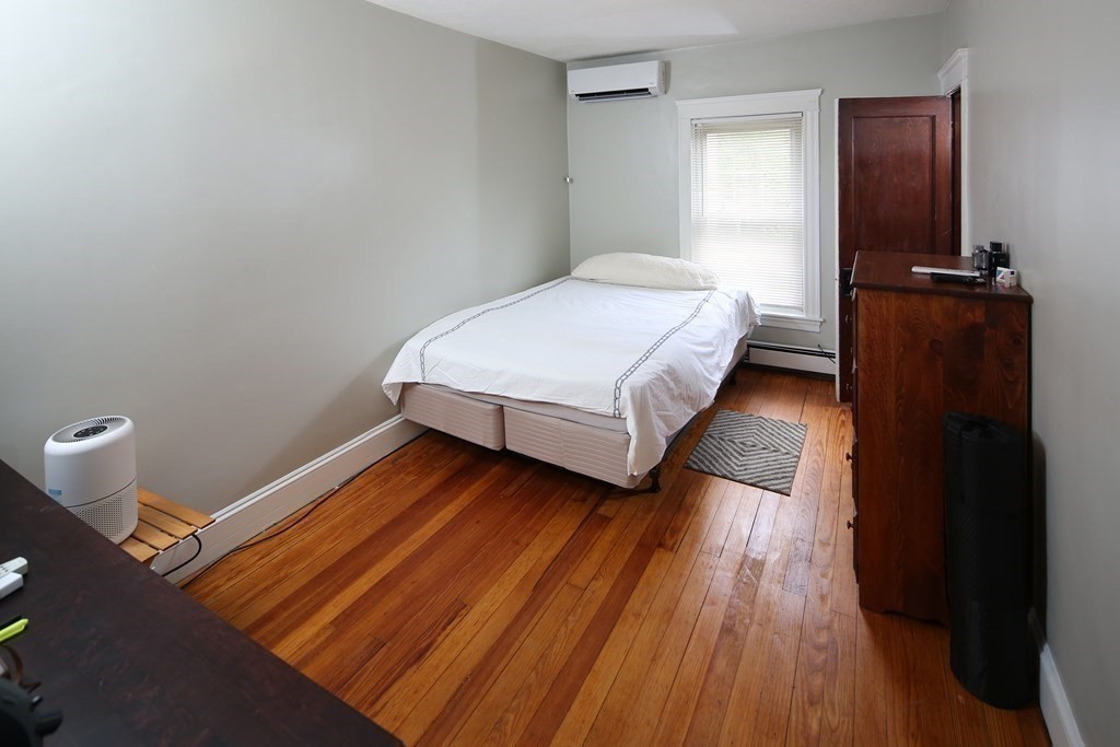137 Mendon Road Attleboro, MA 02703 - Photo 16 of 24 a bedroom with a bed and wooden floor