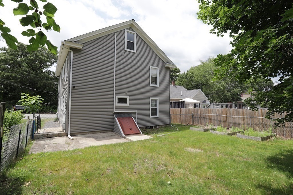 137 Mendon Road Attleboro, MA 02703 - Photo 19 of 24 a view of a backyard with a small cabin and wooden fence