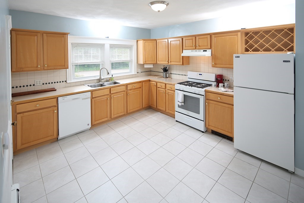 137 Mendon Road Attleboro, MA 02703 - Photo 4 of 24 a kitchen with a white cabinets and white appliances