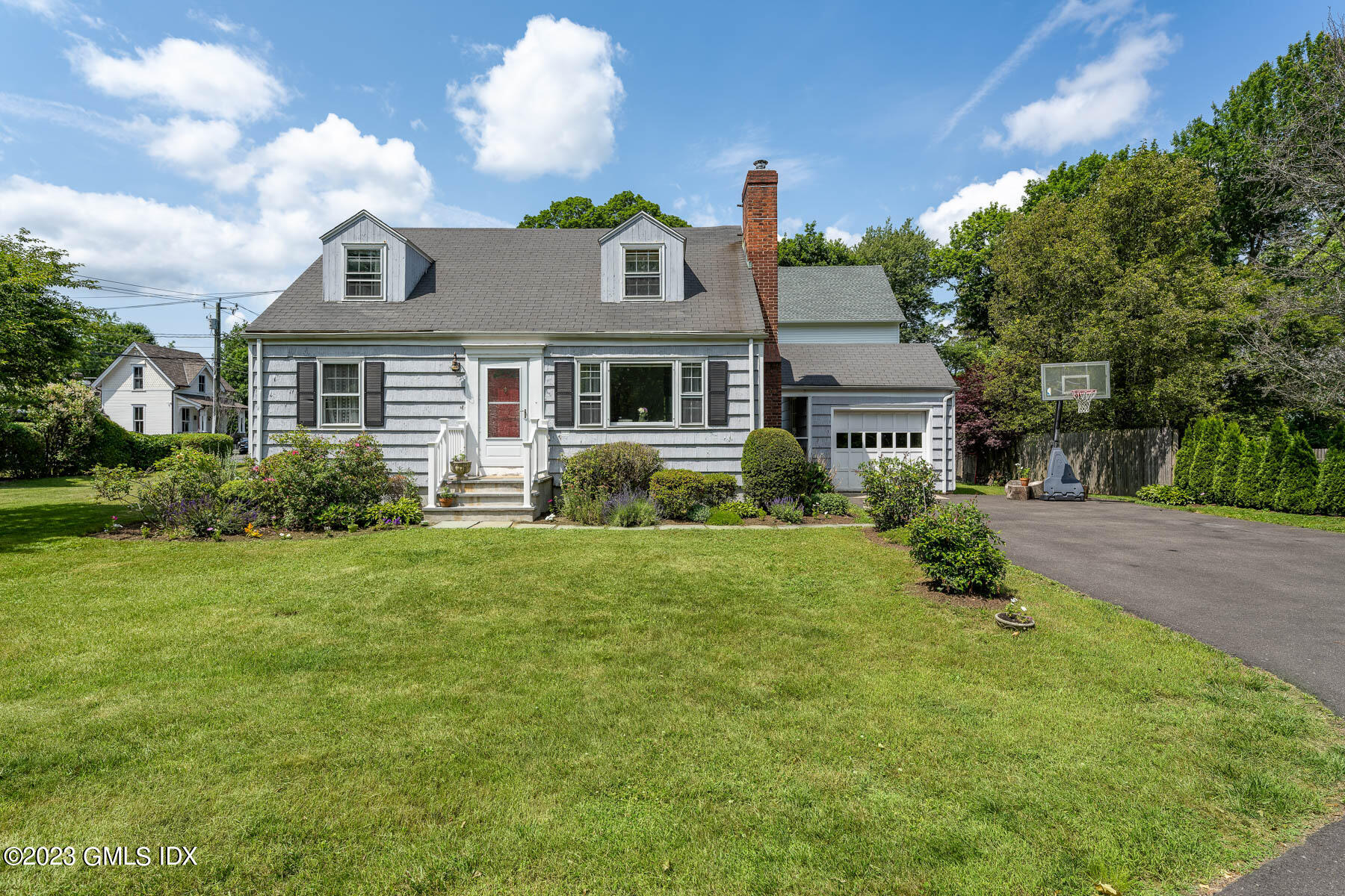 7 Wilmot Lane Riverside, CT 06878 - Photo 1 of 22 a front view of house with yard and green space
