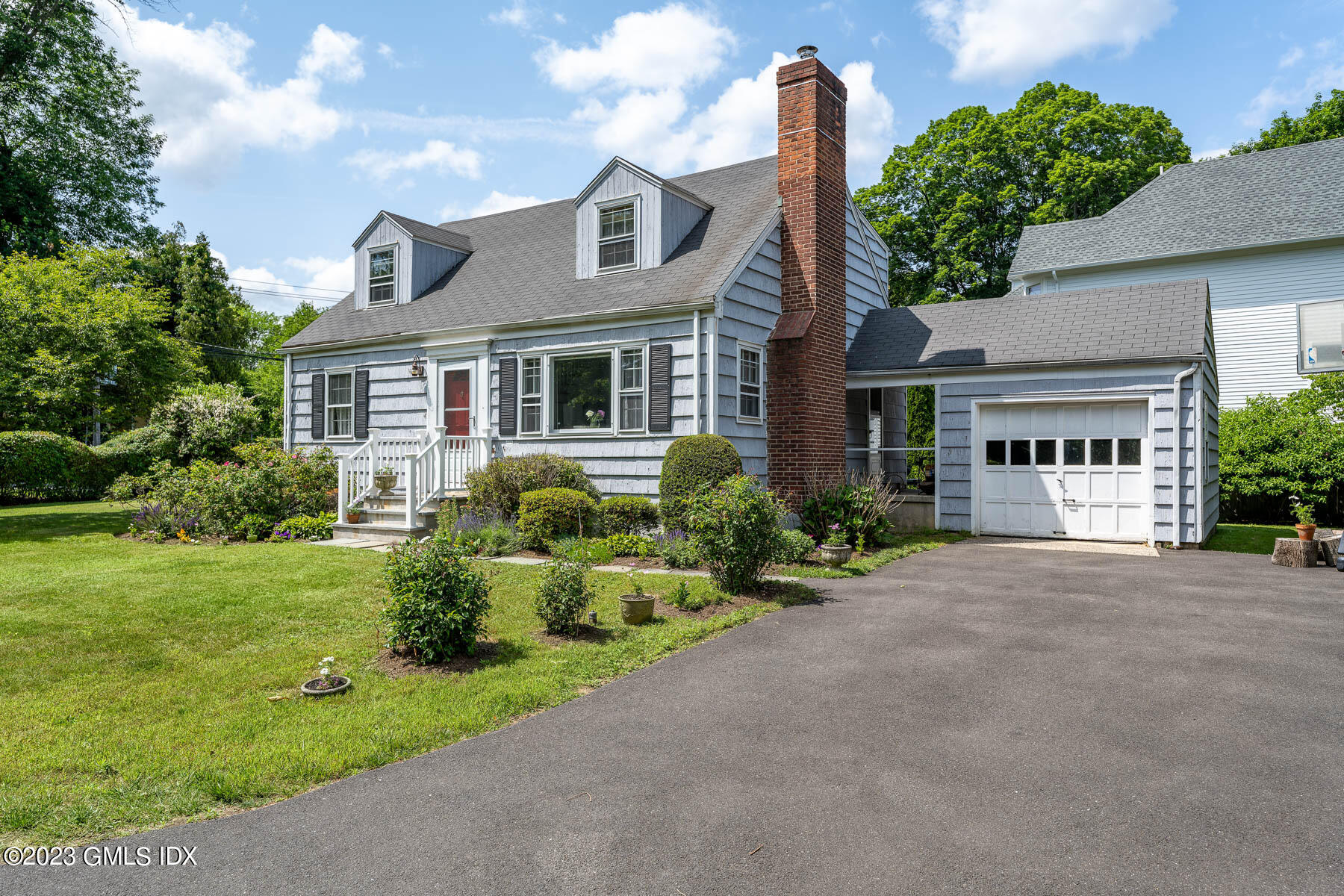 7 Wilmot Lane Riverside, CT 06878 - Photo 2 of 22 front view of a house with a yard