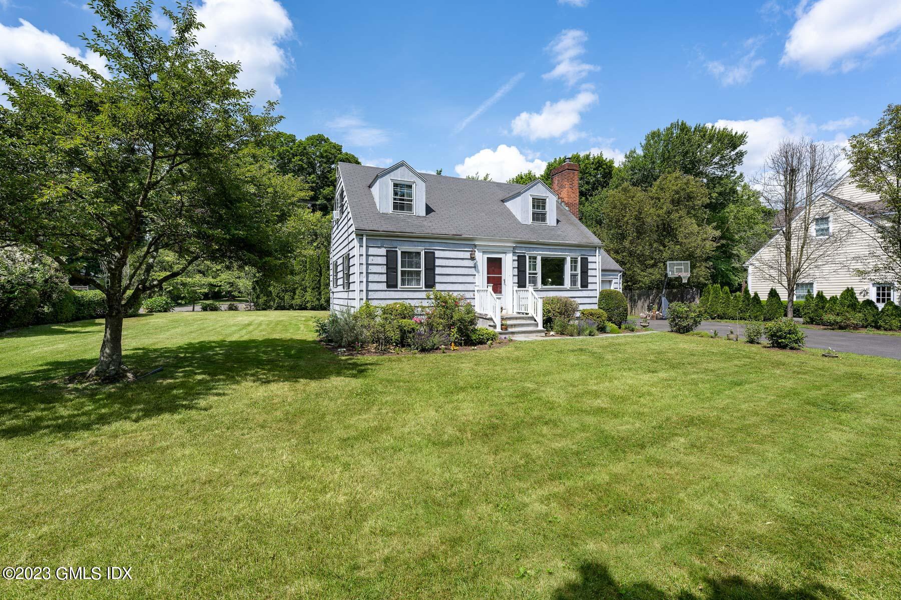 7 Wilmot Lane Riverside, CT 06878 - Photo 3 of 22 a front view of a house with a yard
