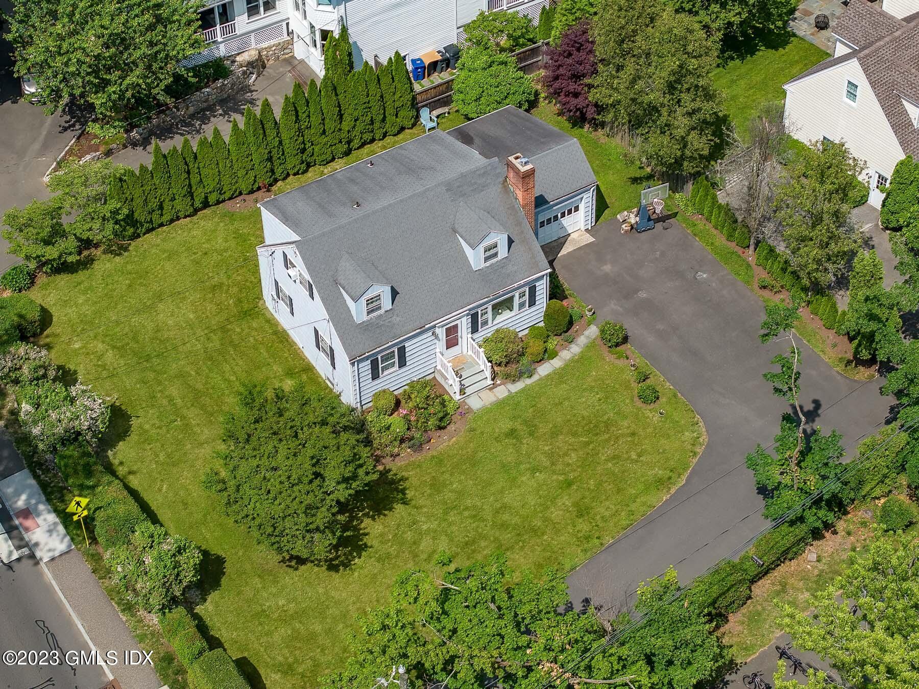 7 Wilmot Lane Riverside, CT 06878 - Photo 4 of 22 an aerial view of a house with a garden and trees