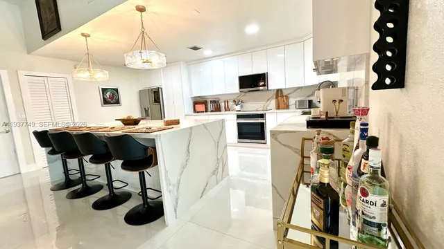 a kitchen with stainless steel appliances kitchen island granite countertop a sink and cabinets