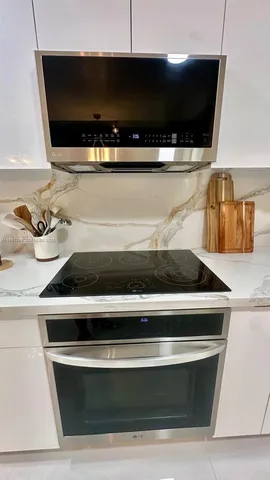a stove top oven sitting inside of a kitchen