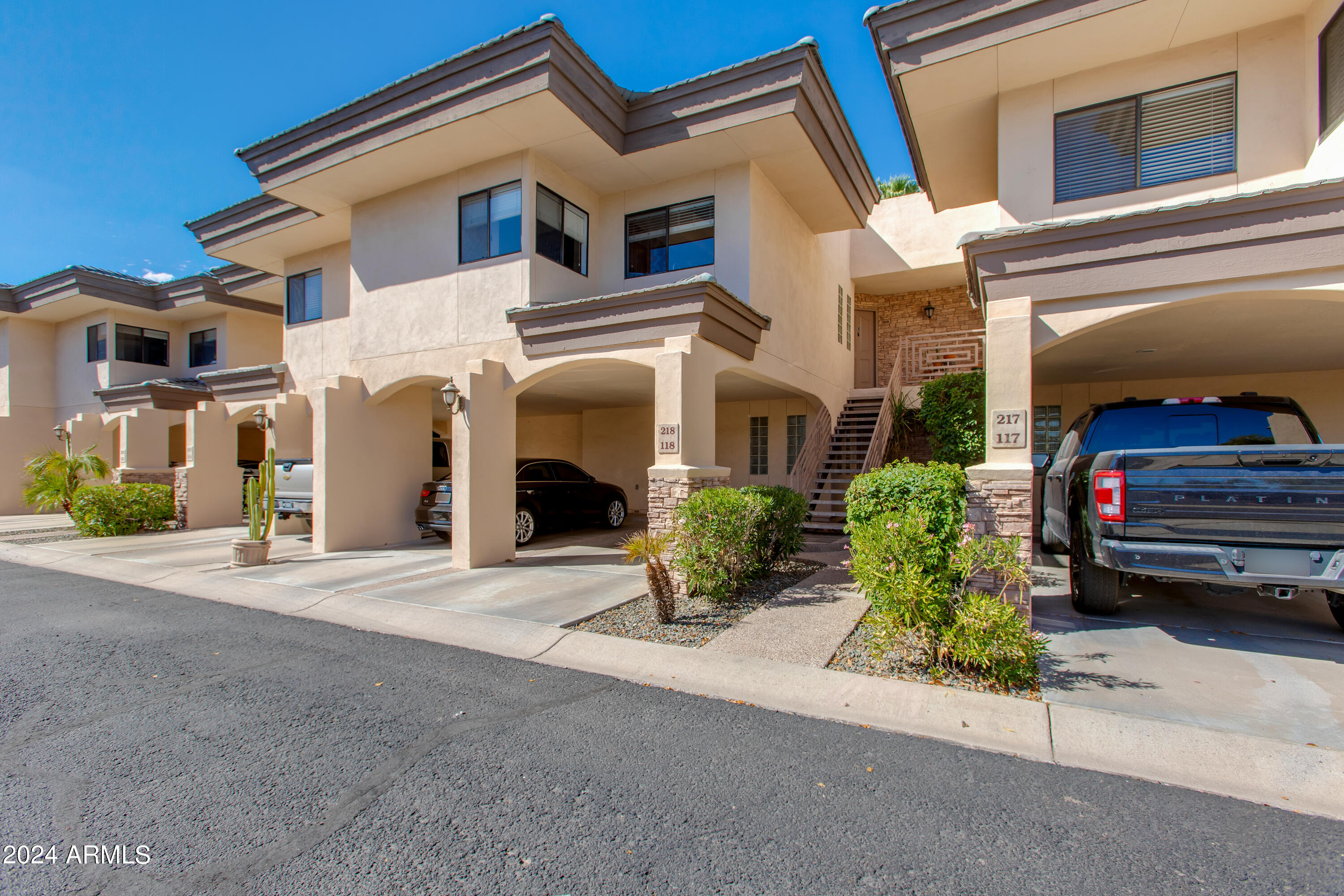 3235 East Camelback Road, Unit 118 Phoenix, AZ 85018 - Photo 1 of 12 a front view of a house with a garage