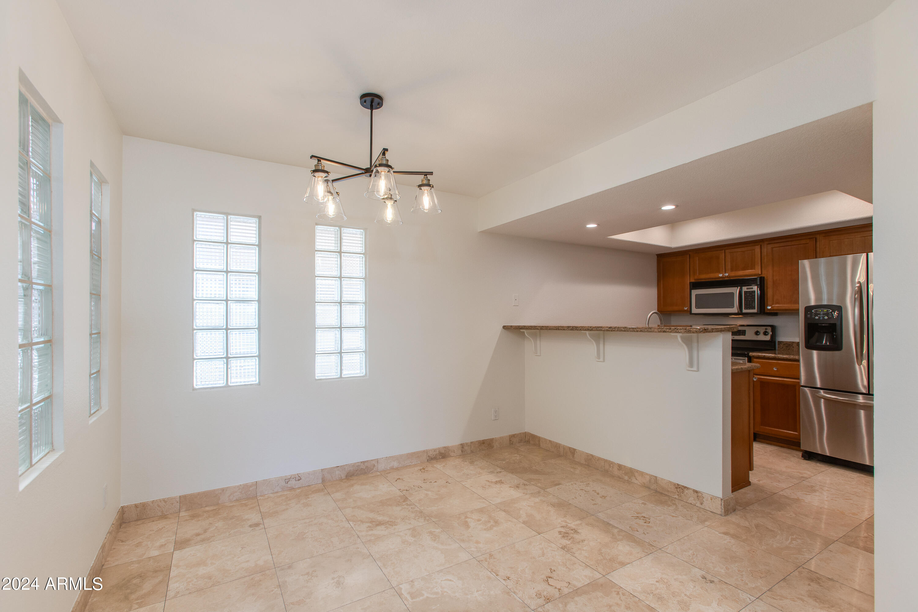 3235 East Camelback Road, Unit 118 Phoenix, AZ 85018 - Photo 3 of 12 a view of a kitchen with a sink and a refrigerator