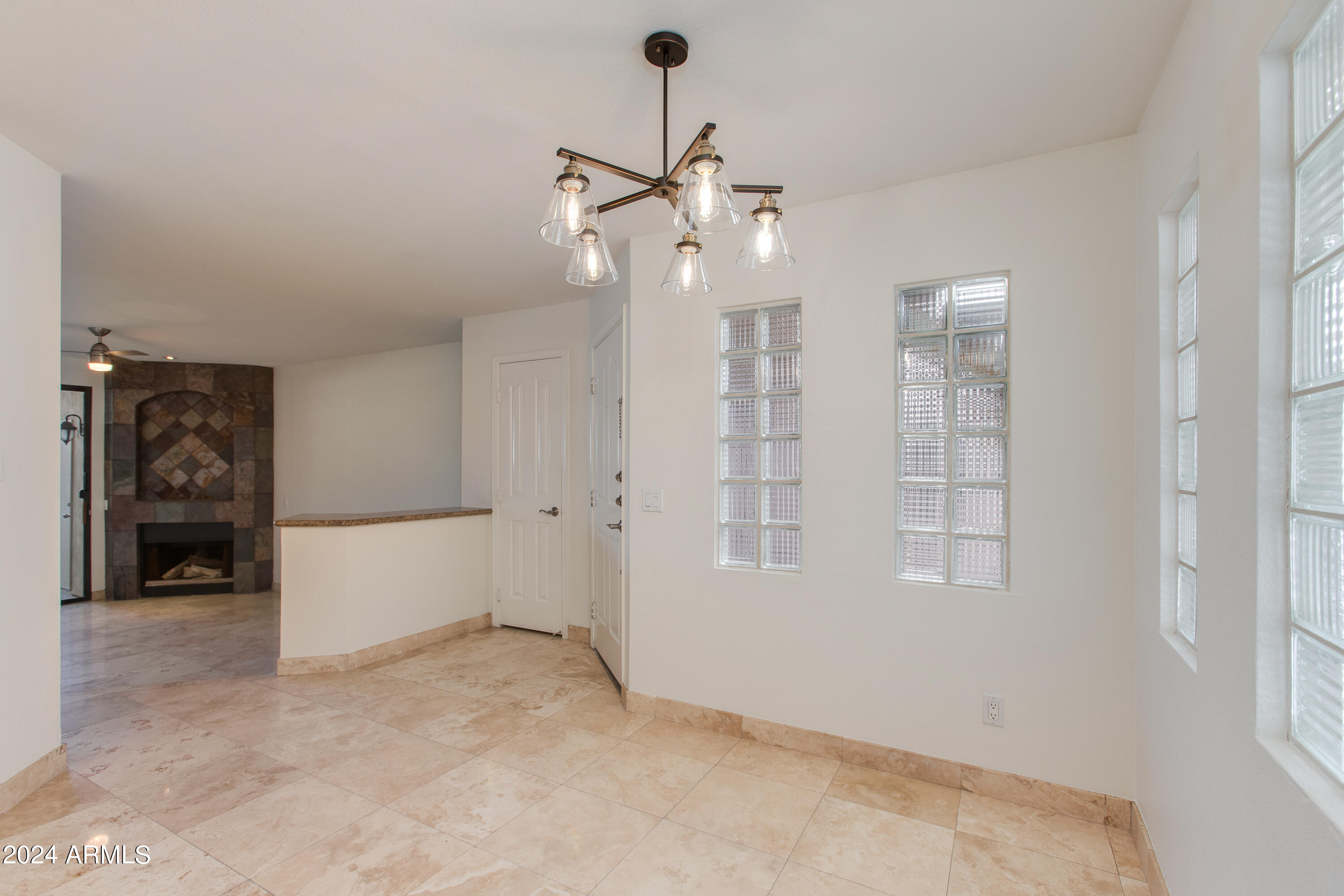 3235 East Camelback Road, Unit 118 Phoenix, AZ 85018 - Photo 6 of 12 wooden floor in an empty room with a window
