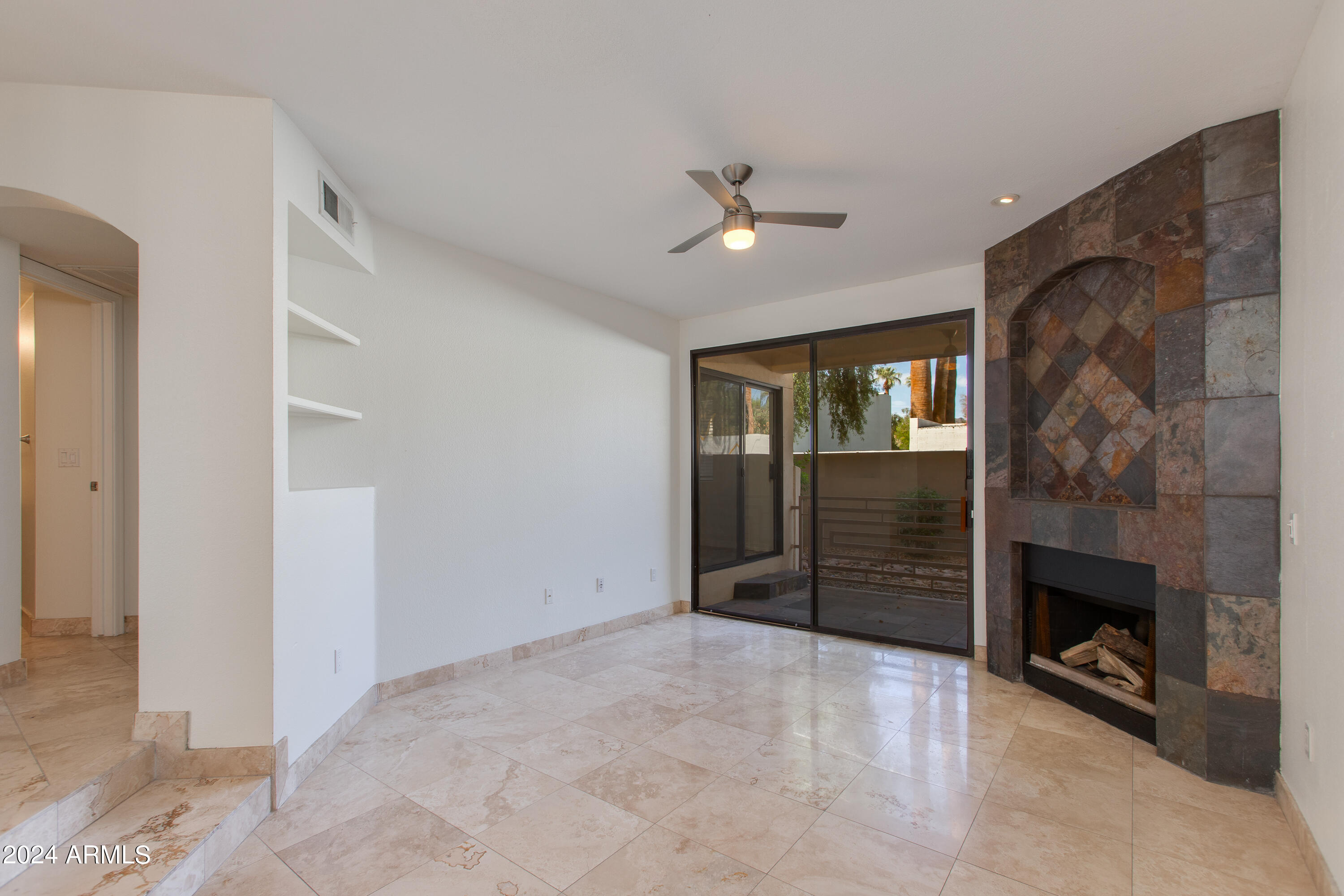 3235 East Camelback Road, Unit 118 Phoenix, AZ 85018 - Photo 7 of 12 a view of an empty room with a fireplace