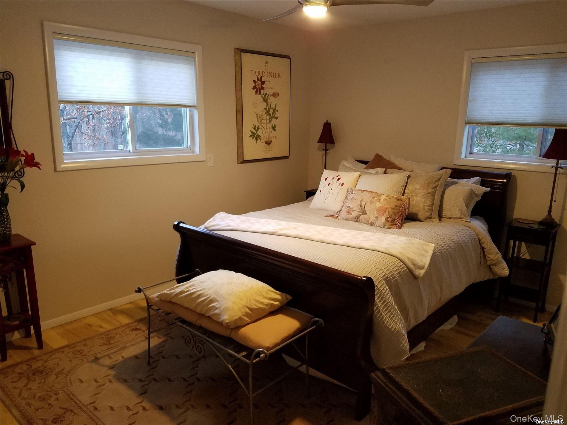 73 Spinney Road East Quogue, NY 11942 - Photo 12 of 20 a bedroom with a bed and a window