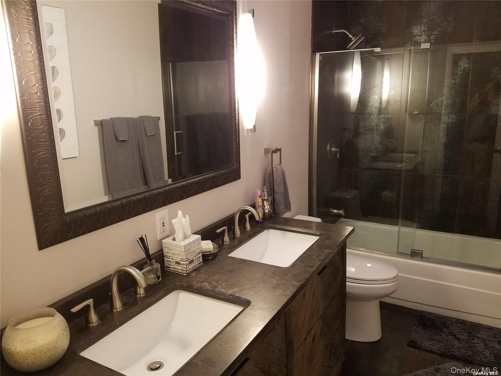 73 Spinney Road East Quogue, NY 11942 - Photo 13 of 20 a bathroom with a sink a toilet a mirror and shower