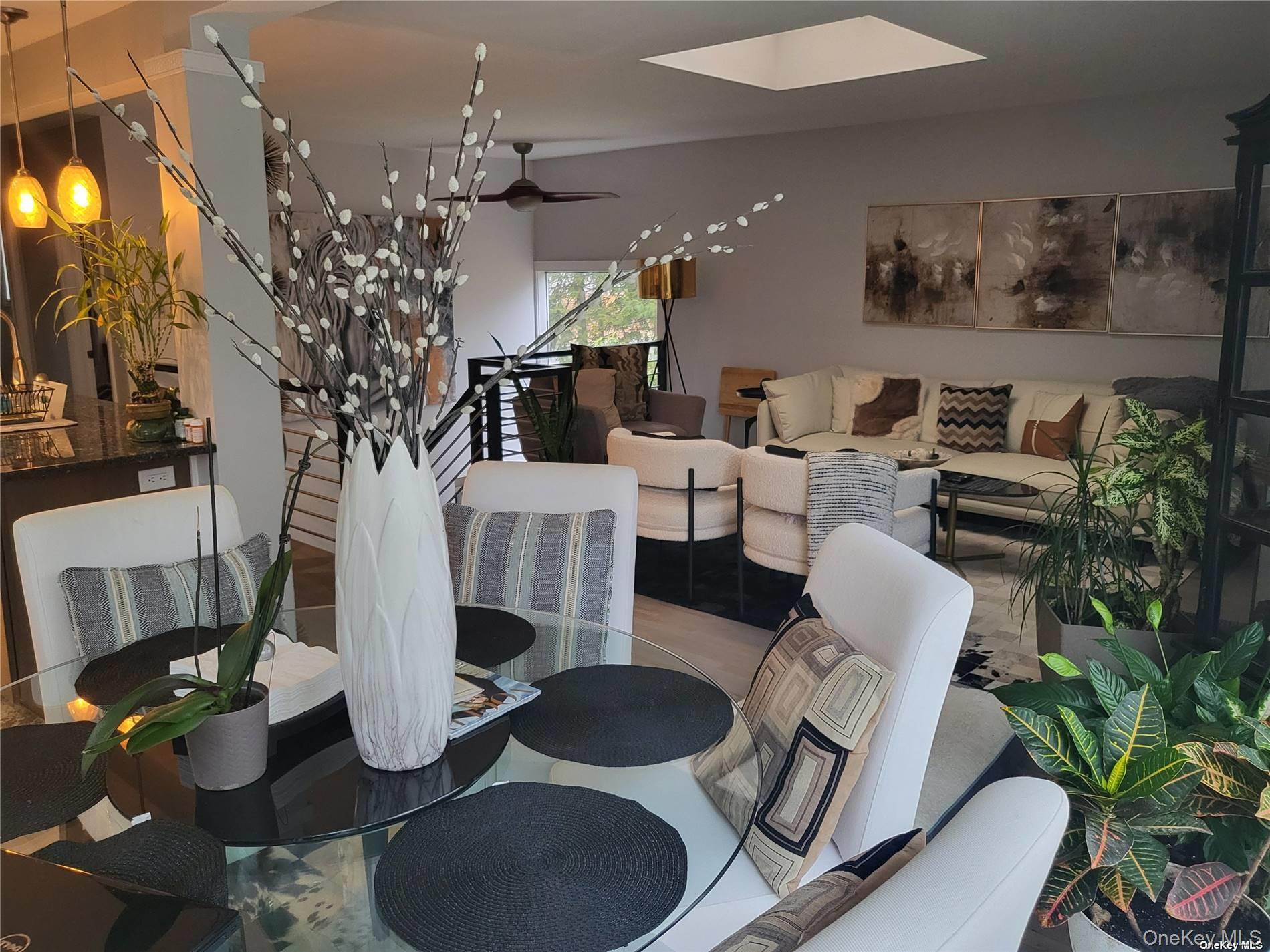 73 Spinney Road East Quogue, NY 11942 - Photo 5 of 20 a living room with furniture a chandelier and a fireplace