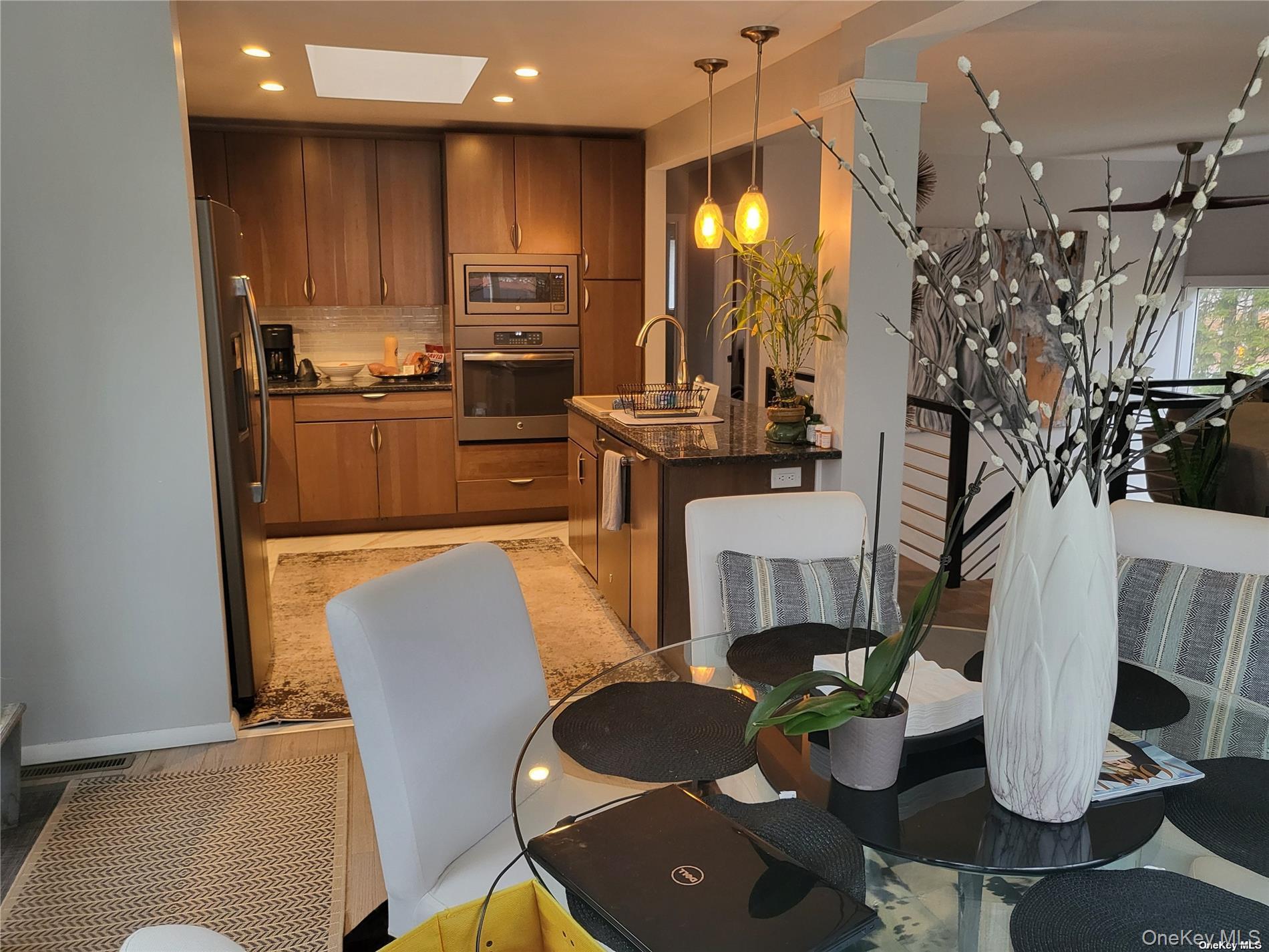 73 Spinney Road East Quogue, NY 11942 - Photo 7 of 20 a dining room with furniture a kitchen view and wooden floor