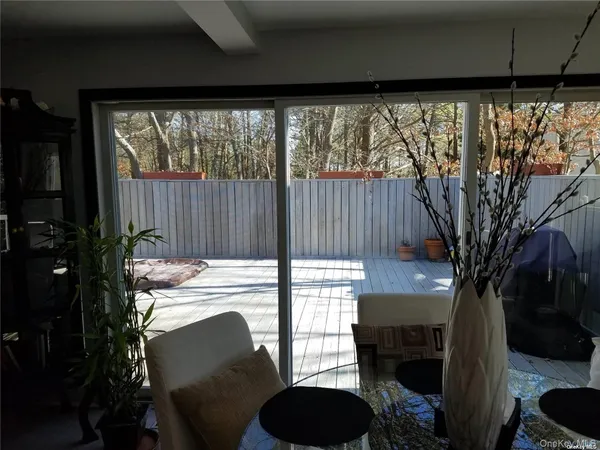 a view of a chairs and table in patio with a fire pit