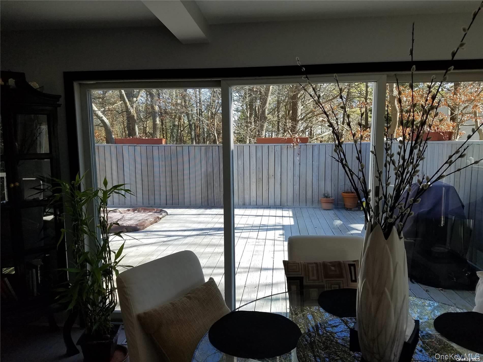 73 Spinney Road East Quogue, NY 11942 - Photo 8 of 20 a view of a chairs and table in patio with a fire pit