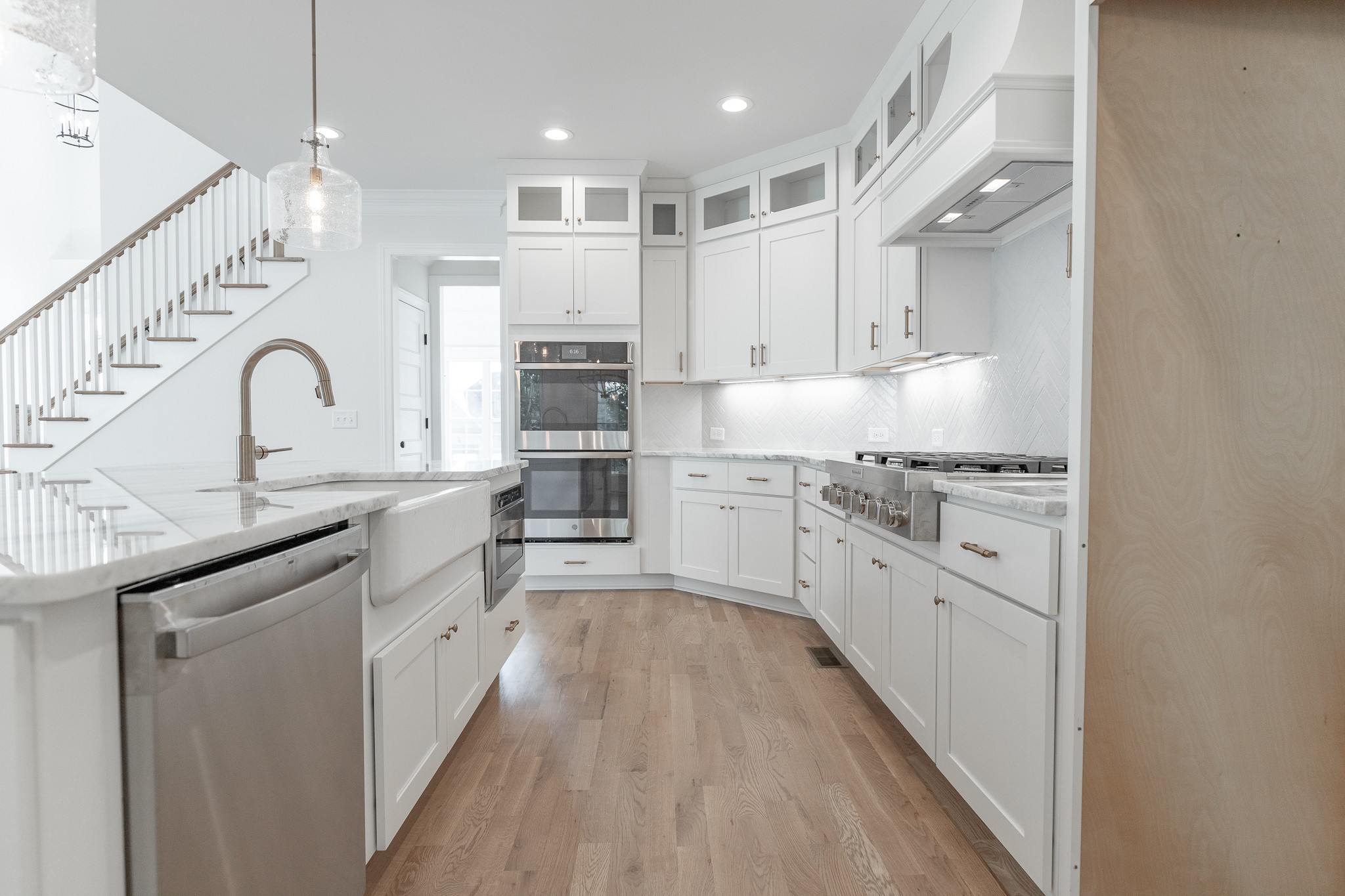 6048 Kidman Lane Spring Hill, TN 37174 - Photo 7 of 31 a kitchen with stainless steel appliances kitchen island granite countertop a sink cabinets and wooden floor