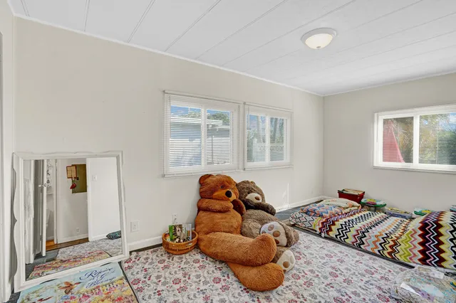 a bedroom with bed and a window