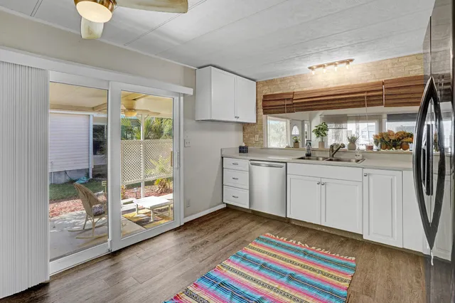 a kitchen with a sink cabinets and wooden floor