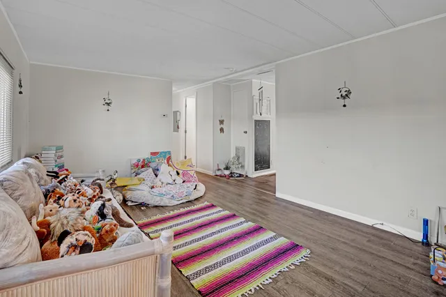 a bedroom with furniture and a wooden floor