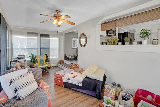 a living room with furniture and wooden floor