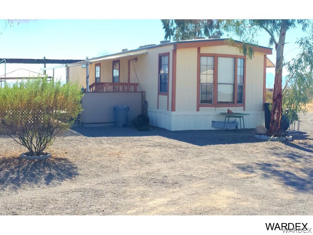 3865 Aztec Road Golden Valley, AZ 86413 - Photo 1 of 26 a front view of a house with a yard